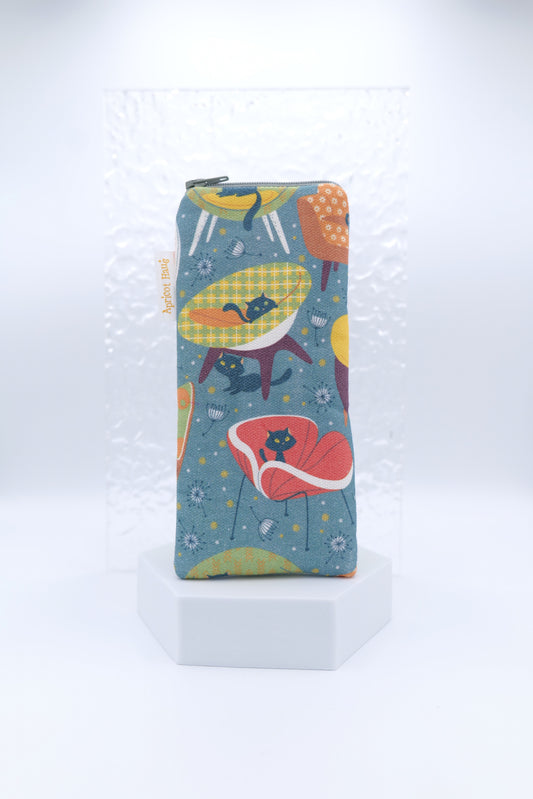 Glasses case featuring the 60s Cats and Chairs design, with stylised black cats sitting on retro-style chairs in red, yellow and green on a dark background; handmade in Melbourne from cotton canvas with a zip top