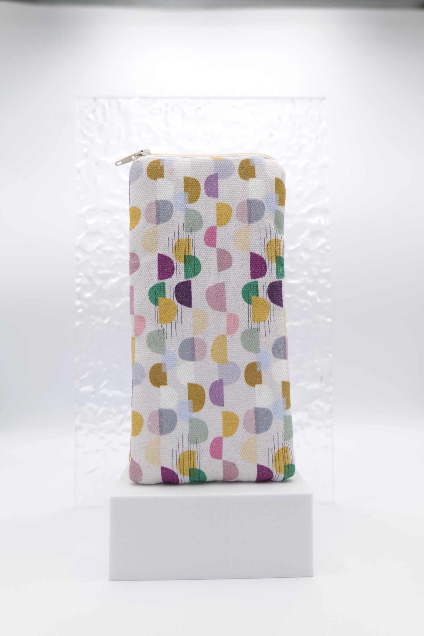 Glasses case featuring the Abstract Skan Pattern design with muted semi-circles and dots arranged in a grid across a soft background; made from cotton canvas with a zip-top closure, padded and lined to protect lenses, handmade in Melbourne and certified Australian Made; pattern placement may vary slightly due to the handmade nature of the product.