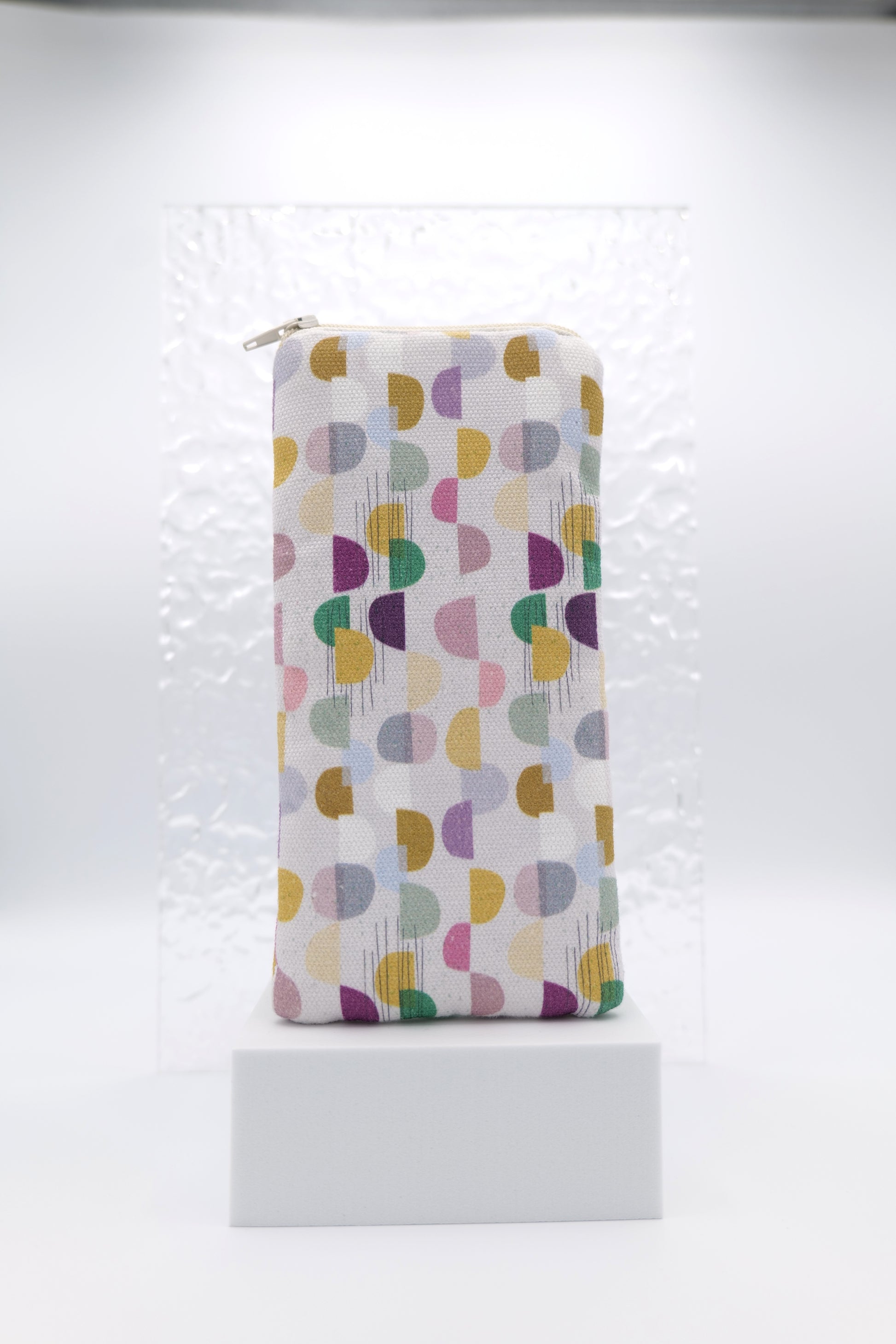 Glasses case featuring the Abstract Skan Pattern design with muted semi-circles and dots arranged in a grid across a soft background; made from cotton canvas with a zip-top closure, padded and lined to protect lenses, handmade in Melbourne and certified Australian Made; pattern placement may vary slightly due to the handmade nature of the product.