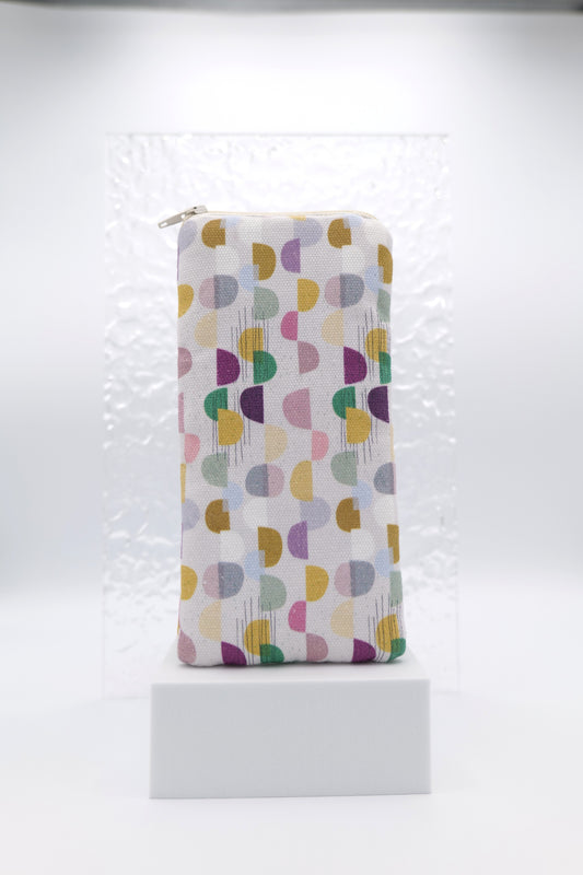 Glasses case featuring the Abstract Skan Pattern design with muted semi-circles and dots arranged in a grid across a soft background; made from cotton canvas with a zip-top closure, padded and lined to protect lenses, handmade in Melbourne and certified Australian Made; pattern placement may vary slightly due to the handmade nature of the product.