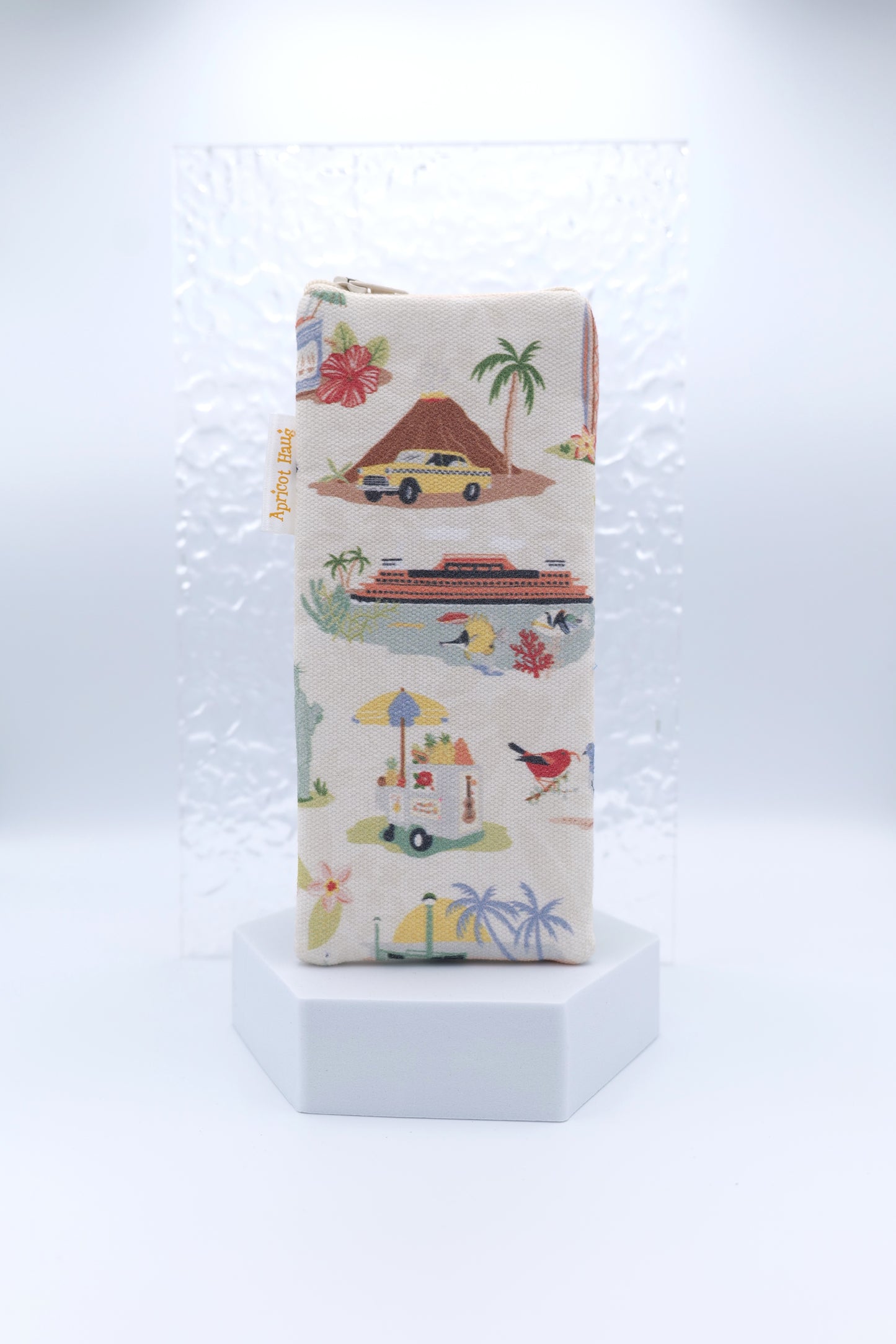 Glasses case featuring the Aloha New York design with colourful retro-style illustrations of volcanoes, yellow taxis, palm trees, cruise ships, birds, beach umbrellas, food carts and flowers on a light background; made from cotton canvas with a zip-top closure, padded and lined to protect lenses, handmade in Melbourne and certified Australian Made; pattern placement may vary slightly due to the handmade nature of the product.