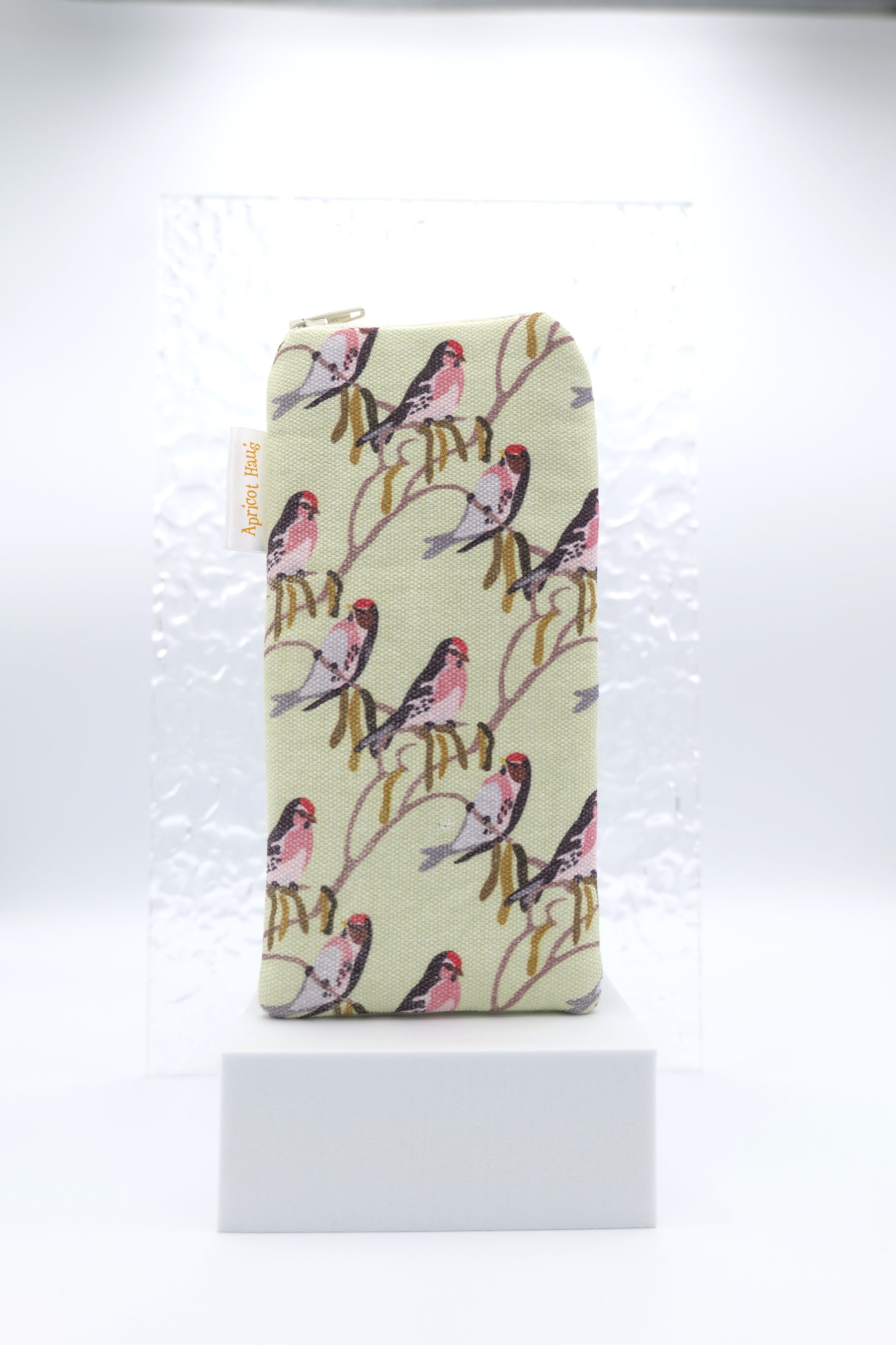 Glasses case featuring a Bird Muster design with colourful, stylised birds arranged in a playful scattered pattern on a soft green background; made from cotton canvas with a zip‑top closure, padded and lined to protect lenses, handmade in Melbourne and certified Australian Made; pattern placement may vary slightly due to the handmade nature of the product.