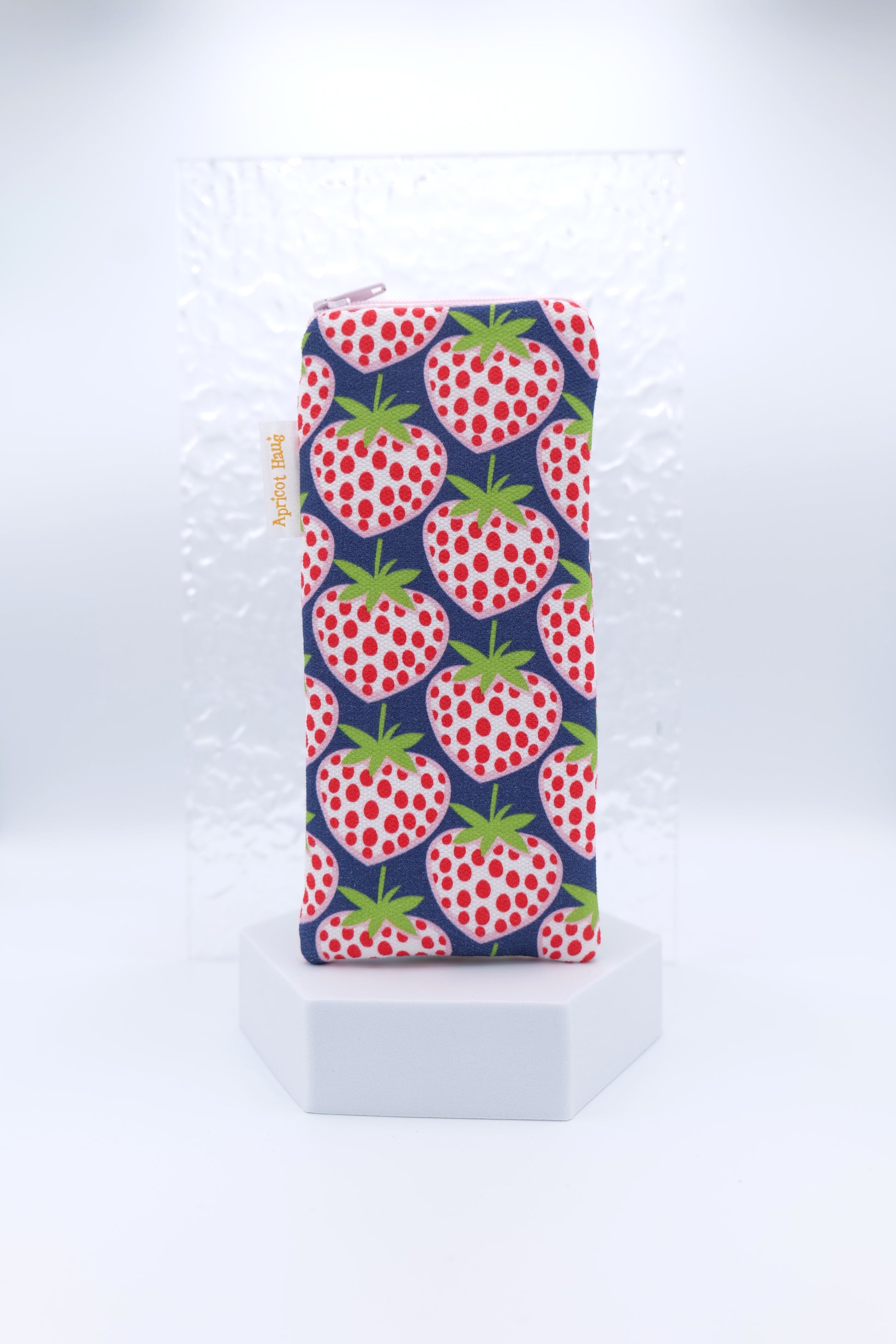 Glasses case featuring a Blue Strawberries design with oversized red and white strawberries scattered across a navy background; made from cotton canvas with a zip‑top closure, padded and lined to protect lenses, handmade in Melbourne and certified Australian Made; pattern placement may vary slightly due to the handmade nature of the product.
