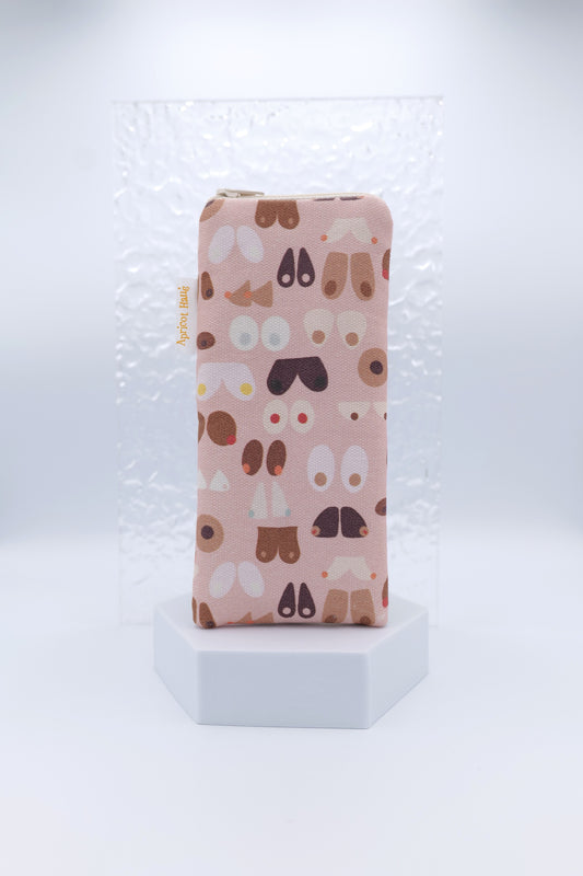 Glasses case with Breasts design featuring abstract, stylised illustrations of breasts in varied shapes and tones on a soft pink background; made from cotton canvas with zip top closure, padded and lined with soft cotton, handmade in Melbourne and certified Australian Made; matching apron and tea towel available; pattern placement may vary slightly and individual items may have small quirks due to the handmade nature of the product.