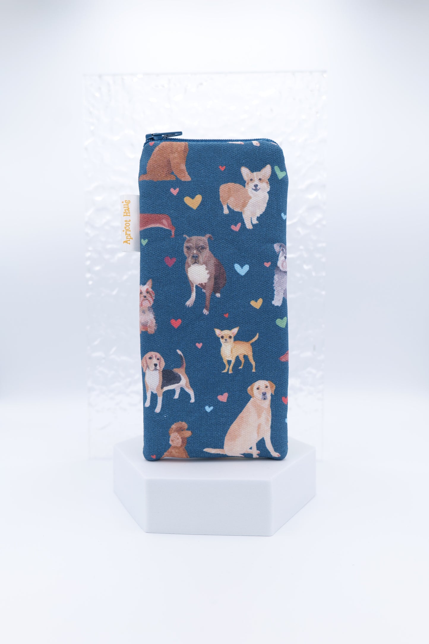 Glasses case featuring the Dog Love design with colourful hand-illustrated dogs in various poses and multicoloured hearts scattered across a dark background; made from cotton canvas with a zip-top closure, padded and lined to protect lenses, handmade in Melbourne and certified Australian Made; pattern placement may vary slightly due to the handmade nature of the product.
