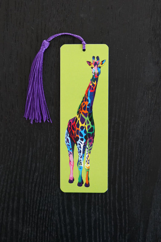Bookmark with a multicoloured giraffe against a lime green background, with a purple tassel; sitting against a black backdrop