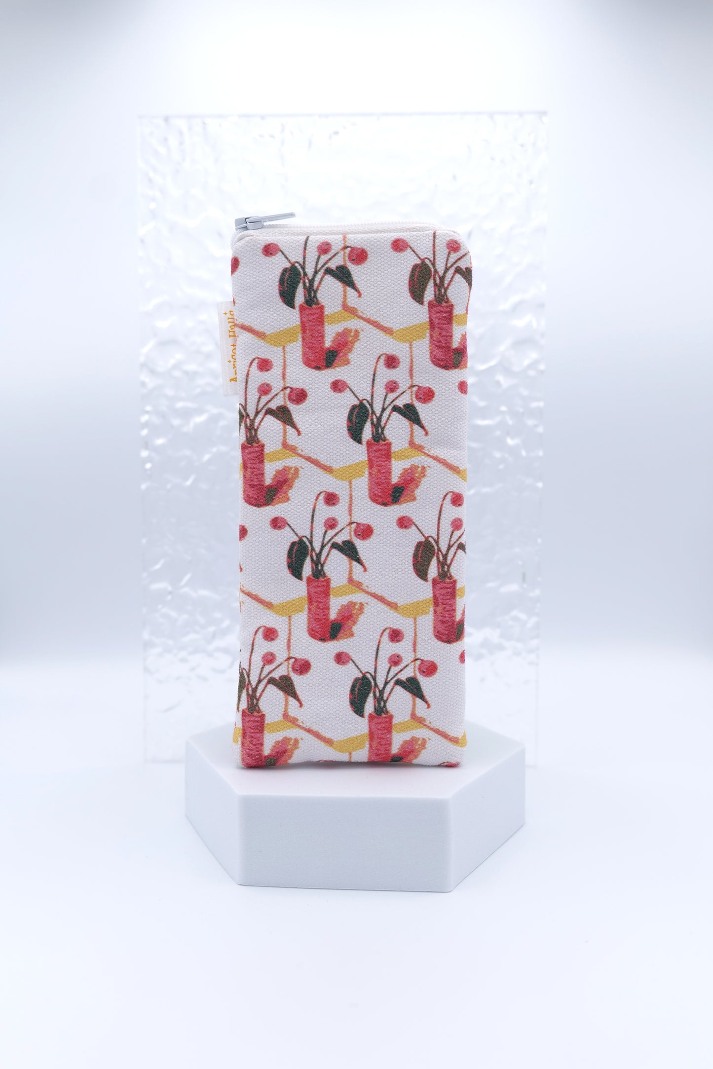 Glasses case with gouache pattern featuring red and pink potted plants with green leaves and berries on a diagonal grid design, made from cotton canvas with zip top closure, padded and lined with soft cotton, handmade in Melbourne and certified Australian Made.