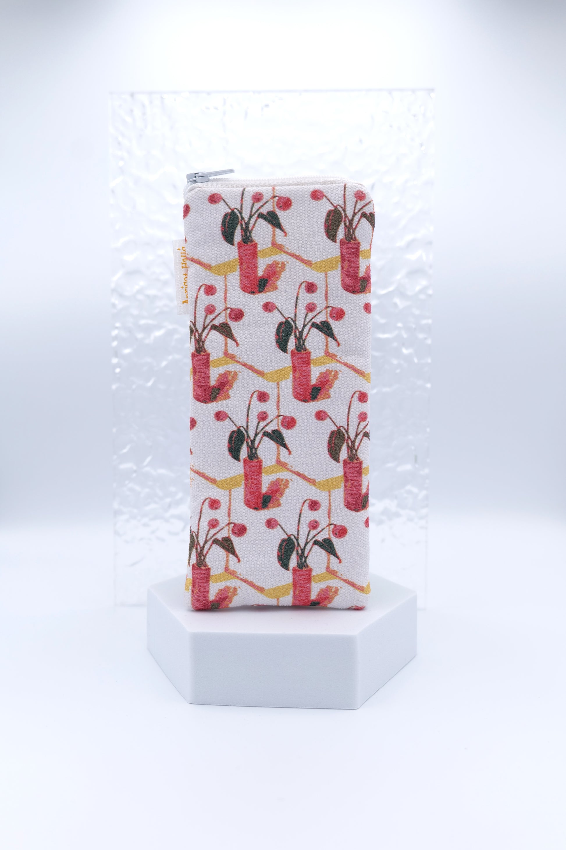 Glasses case with gouache pattern featuring red and pink potted plants with green leaves and berries on a diagonal grid design, made from cotton canvas with zip top closure, padded and lined with soft cotton, handmade in Melbourne and certified Australian Made.