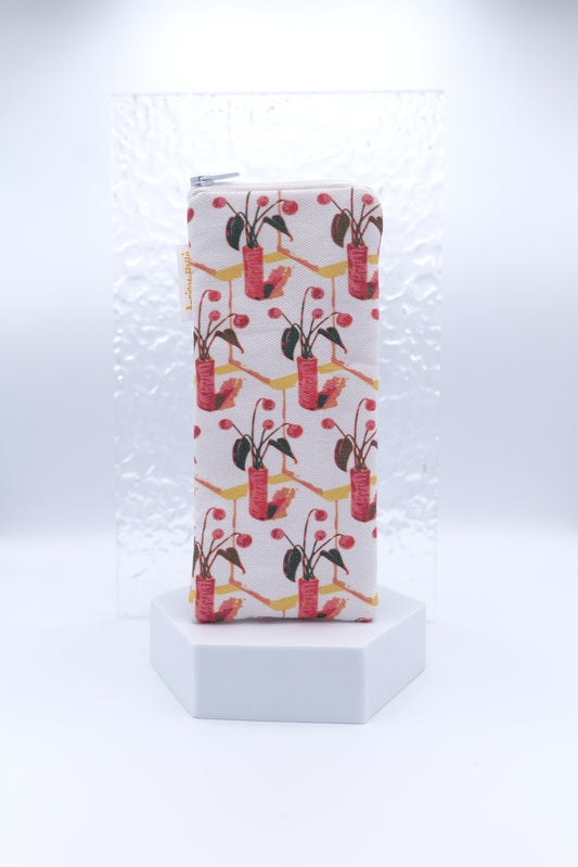 Glasses case with gouache pattern featuring red and pink potted plants with green leaves and berries on a diagonal grid design, made from cotton canvas with zip top closure, padded and lined with soft cotton, handmade in Melbourne and certified Australian Made.