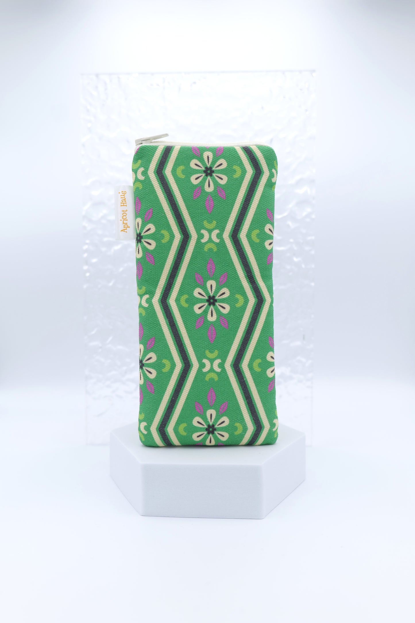 Glasses case with Green Pavilion design featuring symmetrical floral and geometric motifs in green, cream, black and purple; made from cotton canvas with zip top closure, padded and lined with soft cotton, handmade in Melbourne and certified Australian Made.