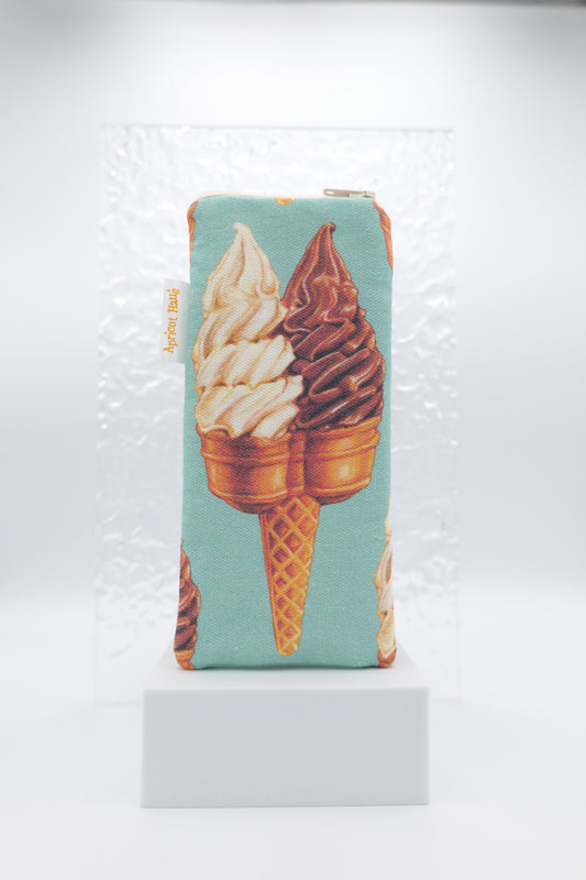 Glasses case featuring a playful double scoop ice‑cream print in a cone on a soft teal background, made from cotton canvas with a zip‑top closure, padded and lined to protect lenses, handmade in Melbourne and certified Australian Made; pattern placement may vary slightly due to the handmade nature of the product.