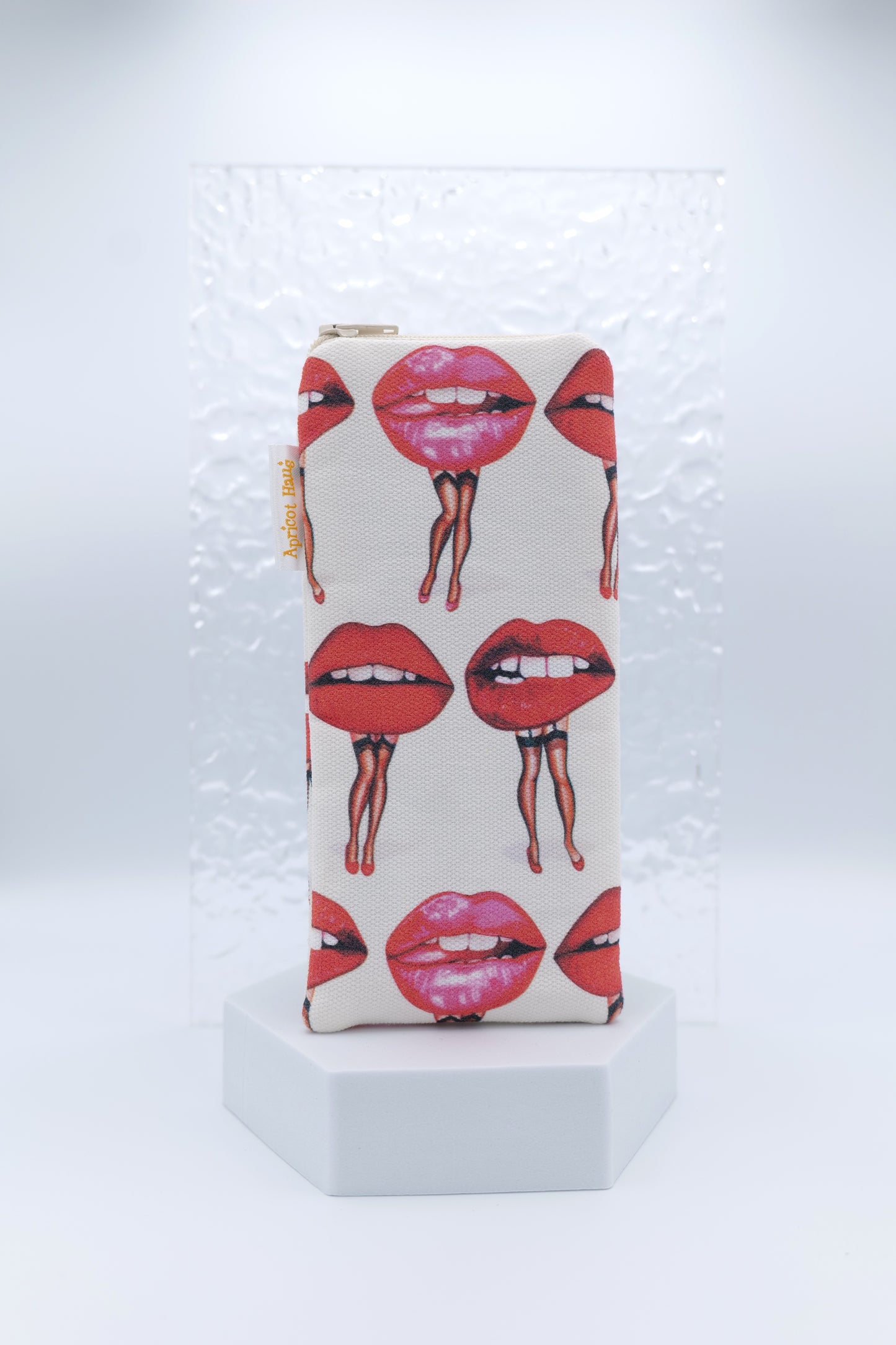 Glasses case featuring the Lips Pin-Ups design with illustrated lips in various expressions, each with legs arranged playfully across the glasses case; made from cotton canvas with a zip-top closure, padded and lined to protect lenses, handmade in Melbourne and certified Australian Made; pattern placement may vary slightly due to the handmade nature of the product.