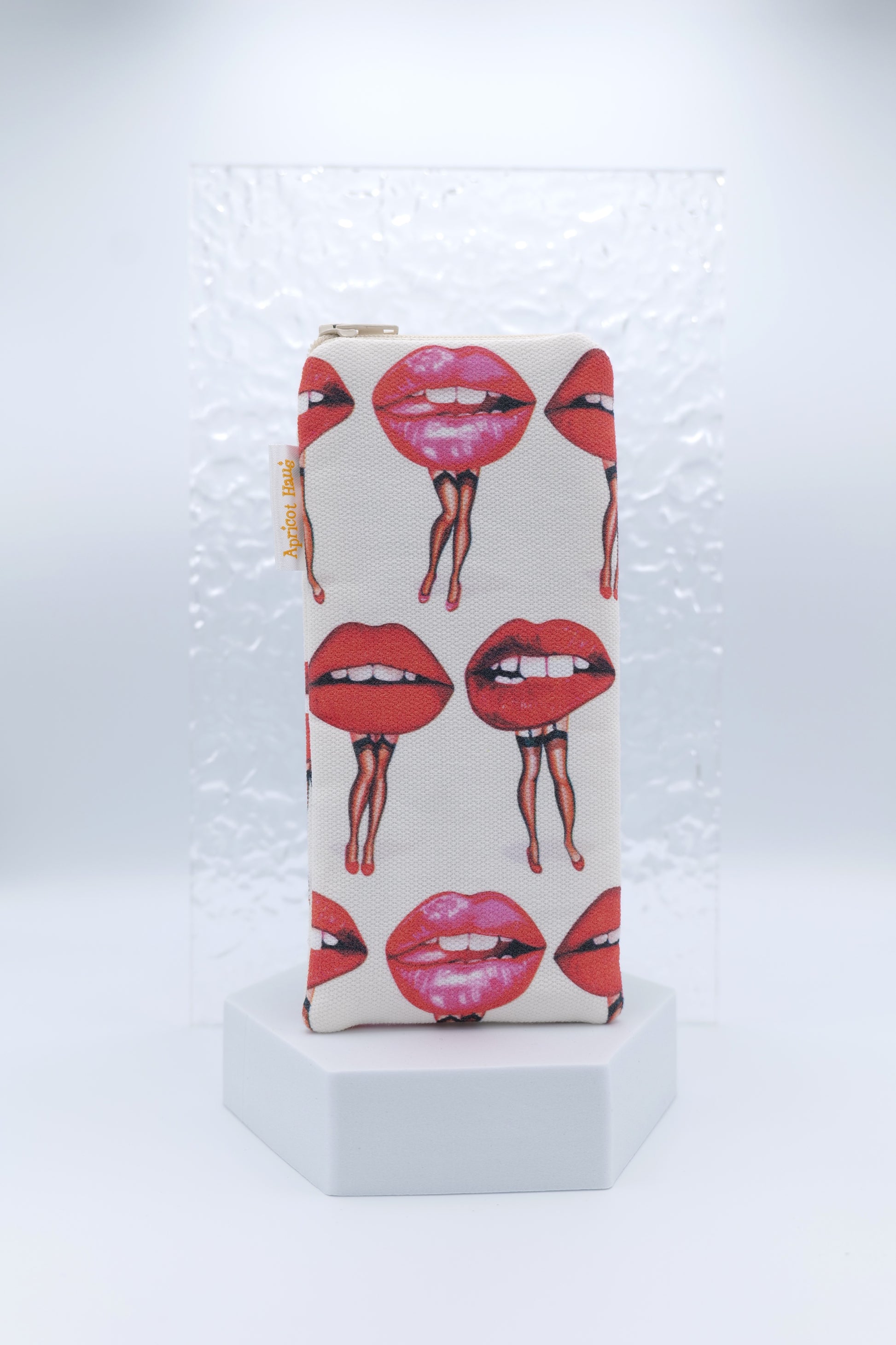 Glasses case featuring the Lips Pin-Ups design with illustrated lips in various expressions, each with legs arranged playfully across the glasses case; made from cotton canvas with a zip-top closure, padded and lined to protect lenses, handmade in Melbourne and certified Australian Made; pattern placement may vary slightly due to the handmade nature of the product.