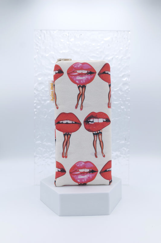Glasses case featuring the Lips Pin-Ups design with illustrated lips in various expressions, each with legs arranged playfully across the glasses case; made from cotton canvas with a zip-top closure, padded and lined to protect lenses, handmade in Melbourne and certified Australian Made; pattern placement may vary slightly due to the handmade nature of the product.