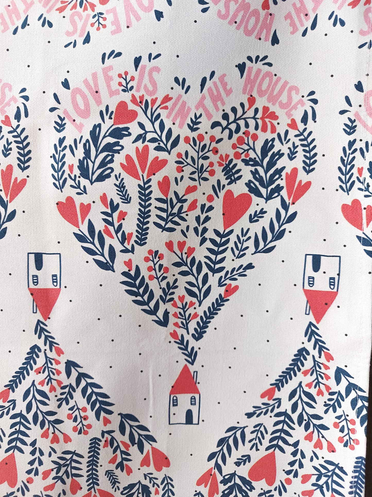 Close up photo of the Love is in the House tea towel design