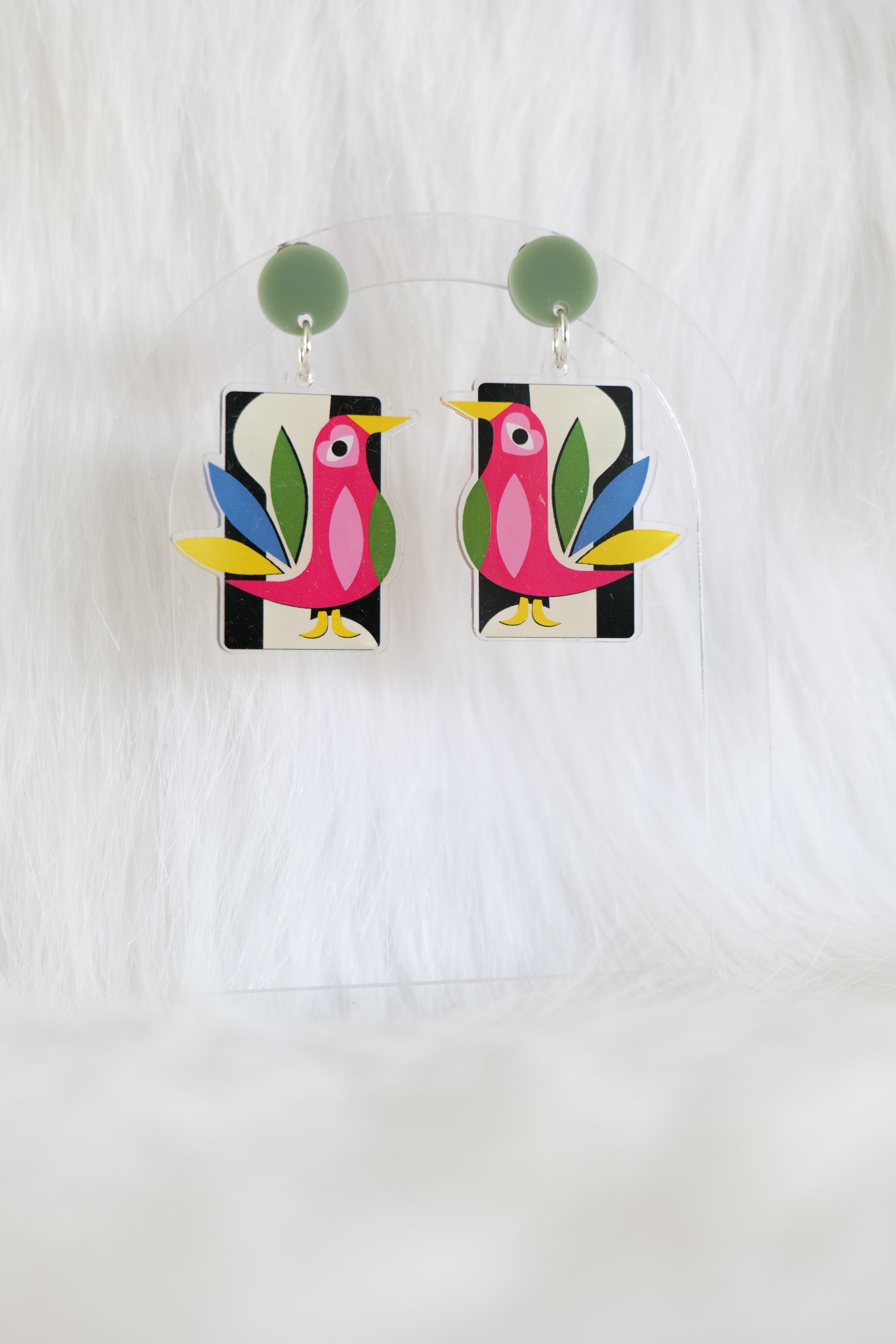 Pair of acrylic earrings featuring stylised mod inspired birds in pink, green, yellow and blue on rectangular drops with olive green stud tops; lightweight with stainless steel posts and large butterfly backs