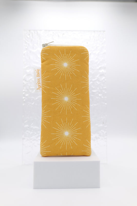 Glasses case with Pulsar Gold design featuring a bold geometric starburst pattern in in white on a gold background; made from cotton canvas with zip top closure, padded and lined with soft cotton, handmade in Melbourne and certified Australian Made; pattern placement may vary slightly due to the handmade nature of the item.