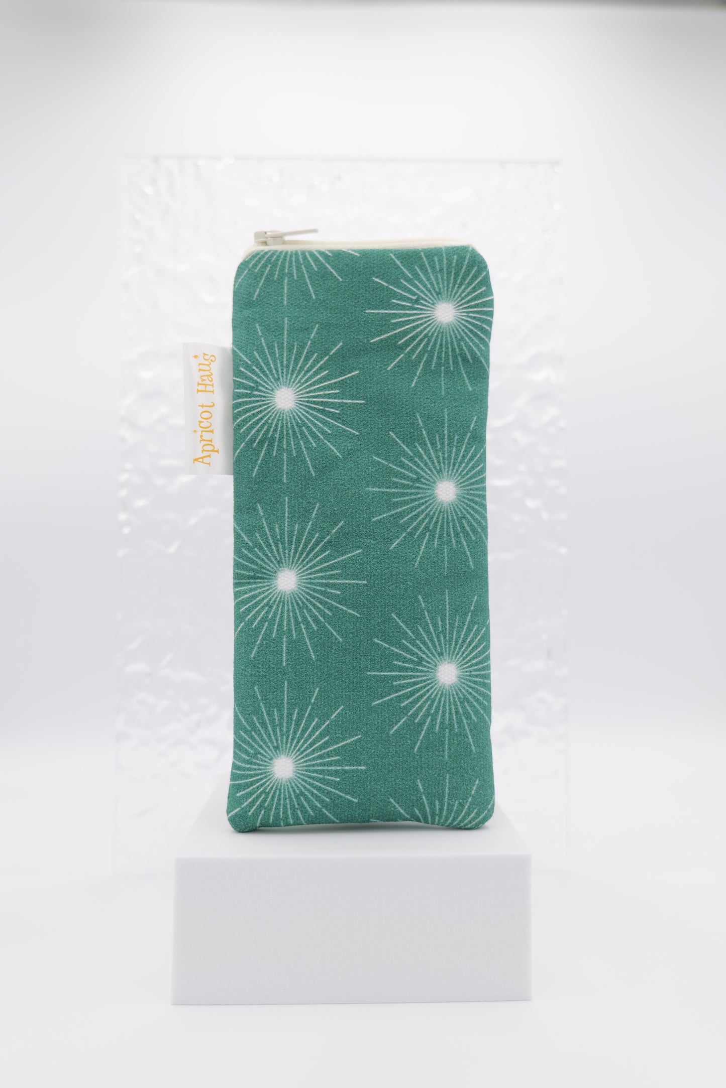 Glasses case featuring the Pulsar Green design with a dynamic white starburst pattern on a dark green background; made from cotton canvas with a zip‑top closure, padded and lined to protect lenses, handmade in Melbourne and certified Australian Made; pattern placement may vary slightly due to the handmade nature of the product.