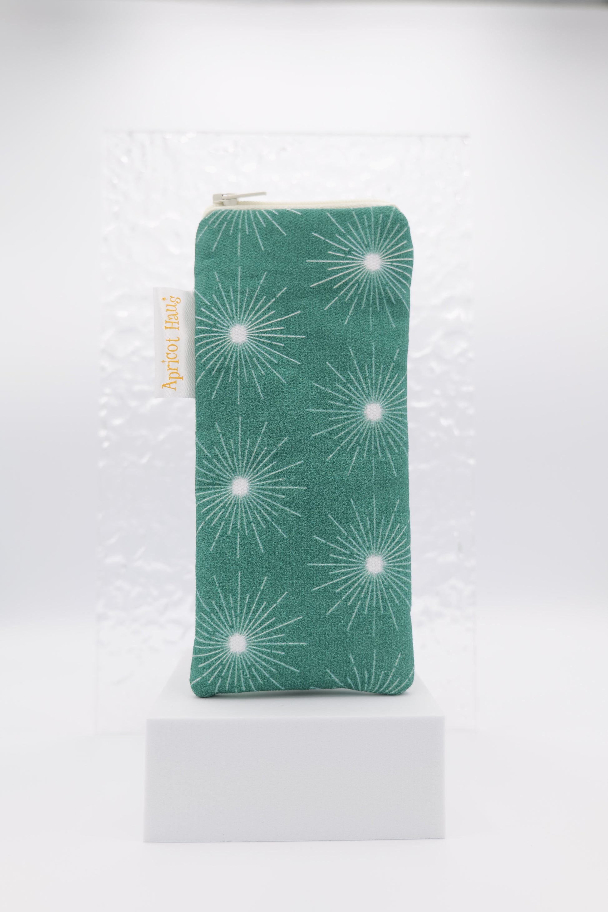 Glasses case featuring the Pulsar Green design with a dynamic white starburst pattern on a dark green background; made from cotton canvas with a zip‑top closure, padded and lined to protect lenses, handmade in Melbourne and certified Australian Made; pattern placement may vary slightly due to the handmade nature of the product.