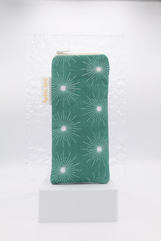 Glasses case featuring the Pulsar Green design with a dynamic white starburst pattern on a dark green background; made from cotton canvas with a zip‑top closure, padded and lined to protect lenses, handmade in Melbourne and certified Australian Made; pattern placement may vary slightly due to the handmade nature of the product.