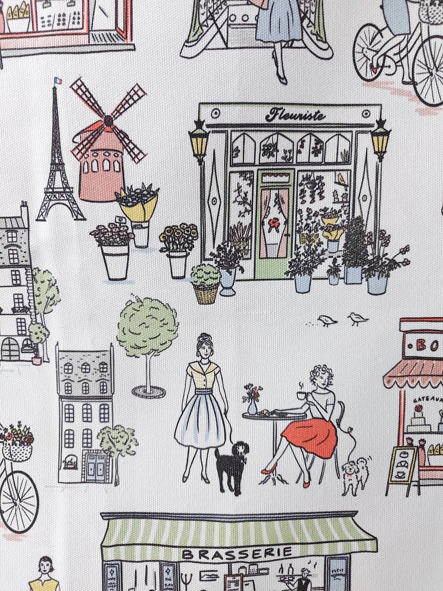 A close up of the Retro Paris design featuring two girls at a cafe and French buildings on a white background