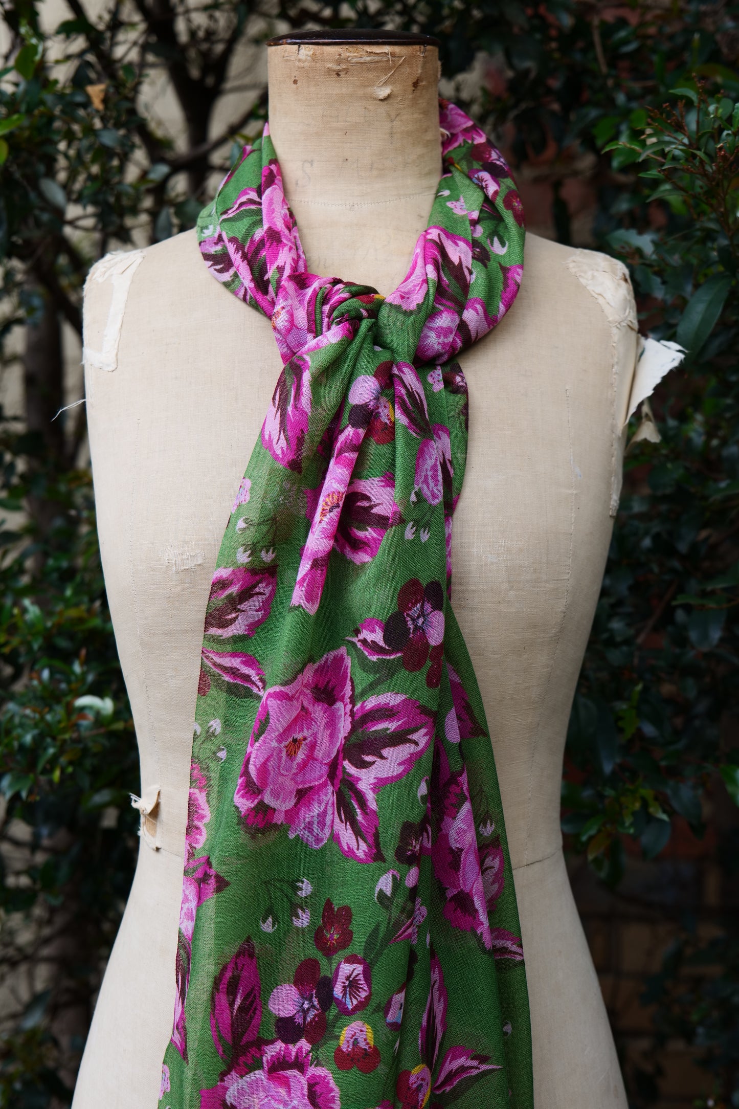 The Rosewood Scarf displayed on a mannequin tied around the neck