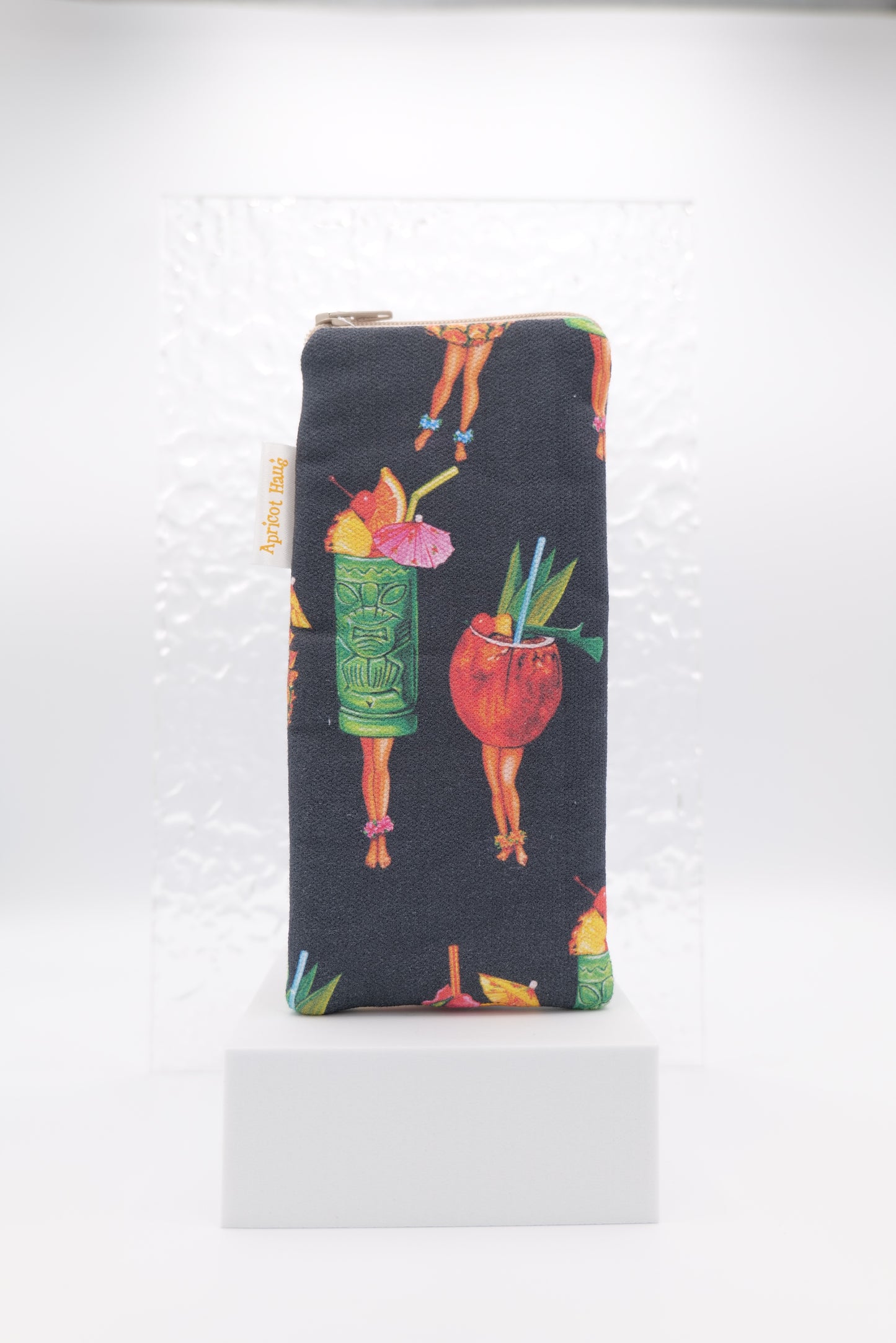 Glasses case with Tiki Cocktail Pin-Ups design featuring colourful tropical cocktails on human legs, decorated with fruit garnishes, umbrellas, and straws; made from cotton canvas with zip top closure, padded and lined with soft cotton, handmade in Melbourne and certified Australian Made; pattern placement may vary slightly and individual items may have small quirks due to the handmade nature of the product.