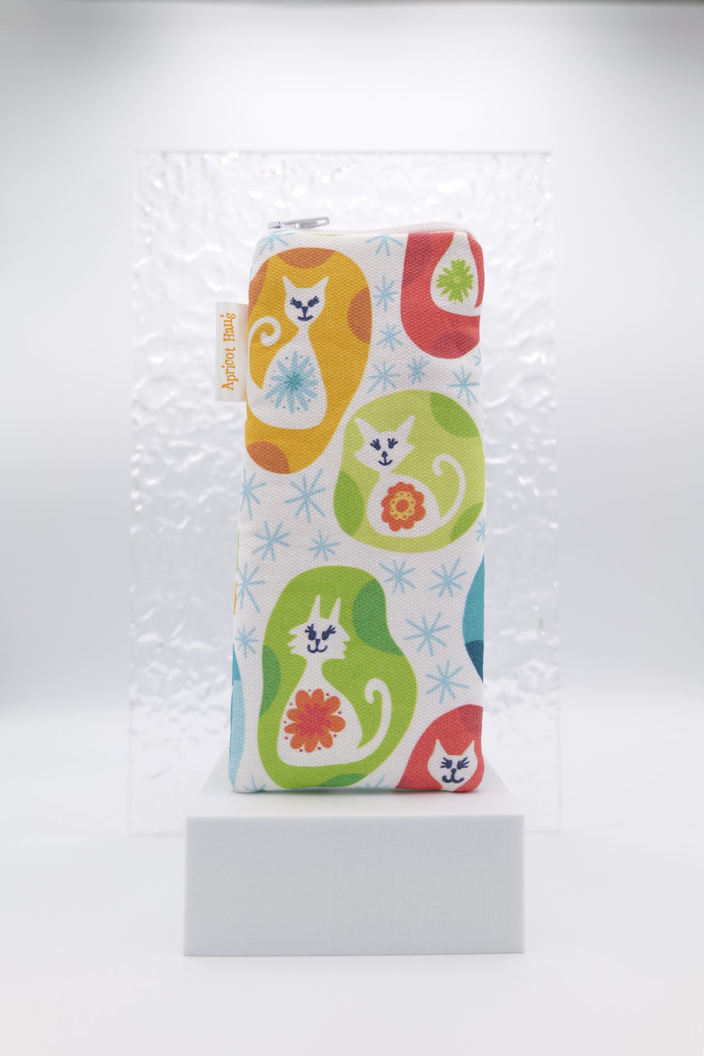 Glasses case featuring Vintage Kitty design with colourful stylised cats, floral motifs and starburst accents on a white background; made from cotton canvas with a zip-top closure, padded and lined to protect lenses, handmade in Melbourne and certified Australian Made; pattern placement may vary slightly due to the handmade nature of the product.
