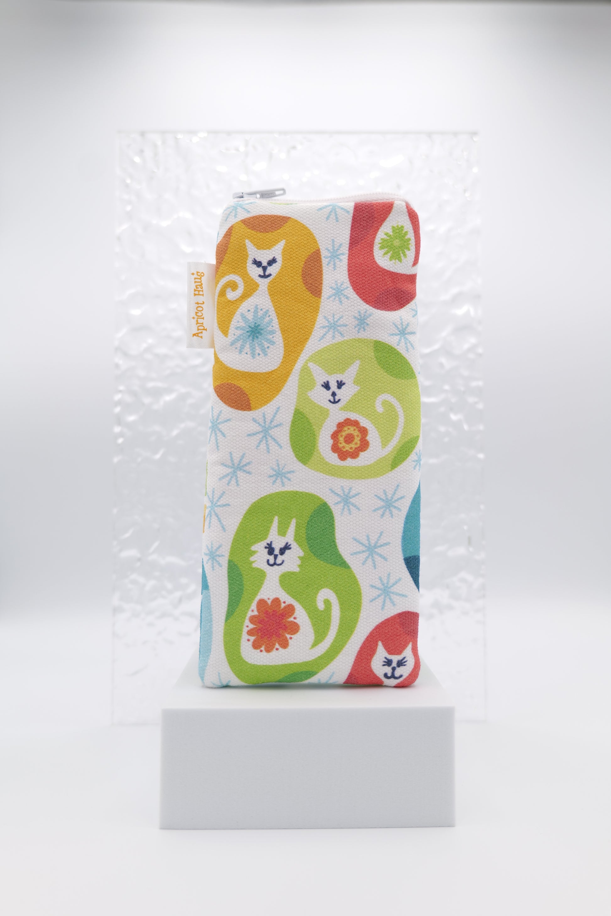 Glasses case featuring Vintage Kitty design with colourful stylised cats, floral motifs and starburst accents on a white background; made from cotton canvas with a zip-top closure, padded and lined to protect lenses, handmade in Melbourne and certified Australian Made; pattern placement may vary slightly due to the handmade nature of the product.