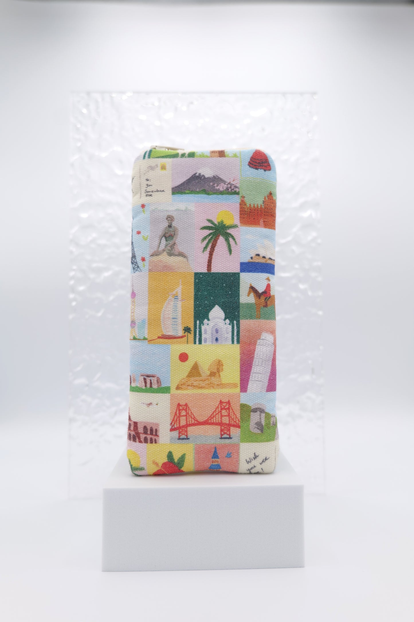 Glasses case featuring the Wish You Were Here design with illustrated travel landmarks arranged across the glasses case; made from cotton canvas with a zip‑top closure, padded and lined to protect lenses, handmade in Melbourne and certified Australian Made; pattern placement may vary slightly due to the handmade nature of the product.