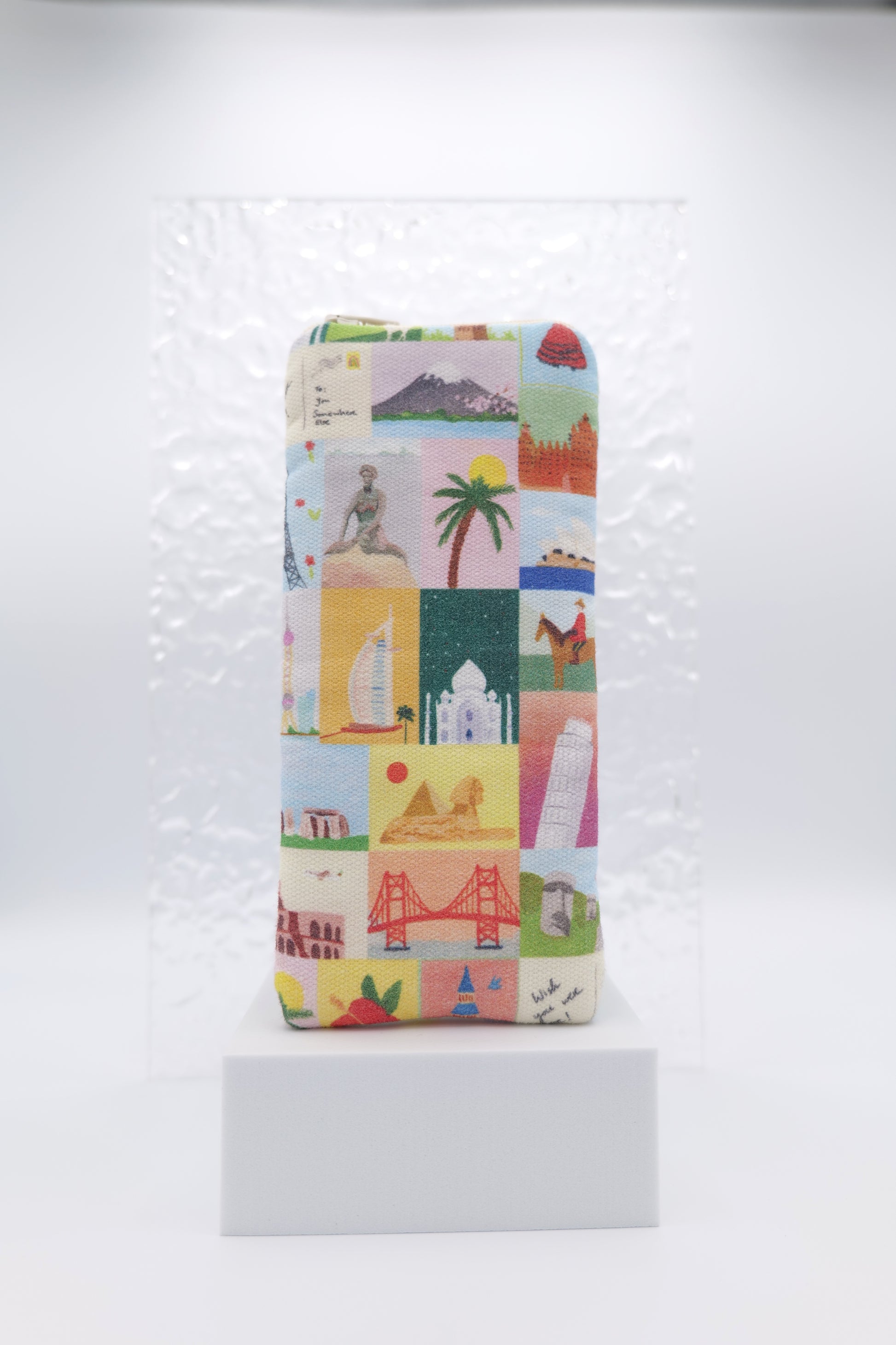 Glasses case featuring the Wish You Were Here design with illustrated travel landmarks arranged across the glasses case; made from cotton canvas with a zip‑top closure, padded and lined to protect lenses, handmade in Melbourne and certified Australian Made; pattern placement may vary slightly due to the handmade nature of the product.